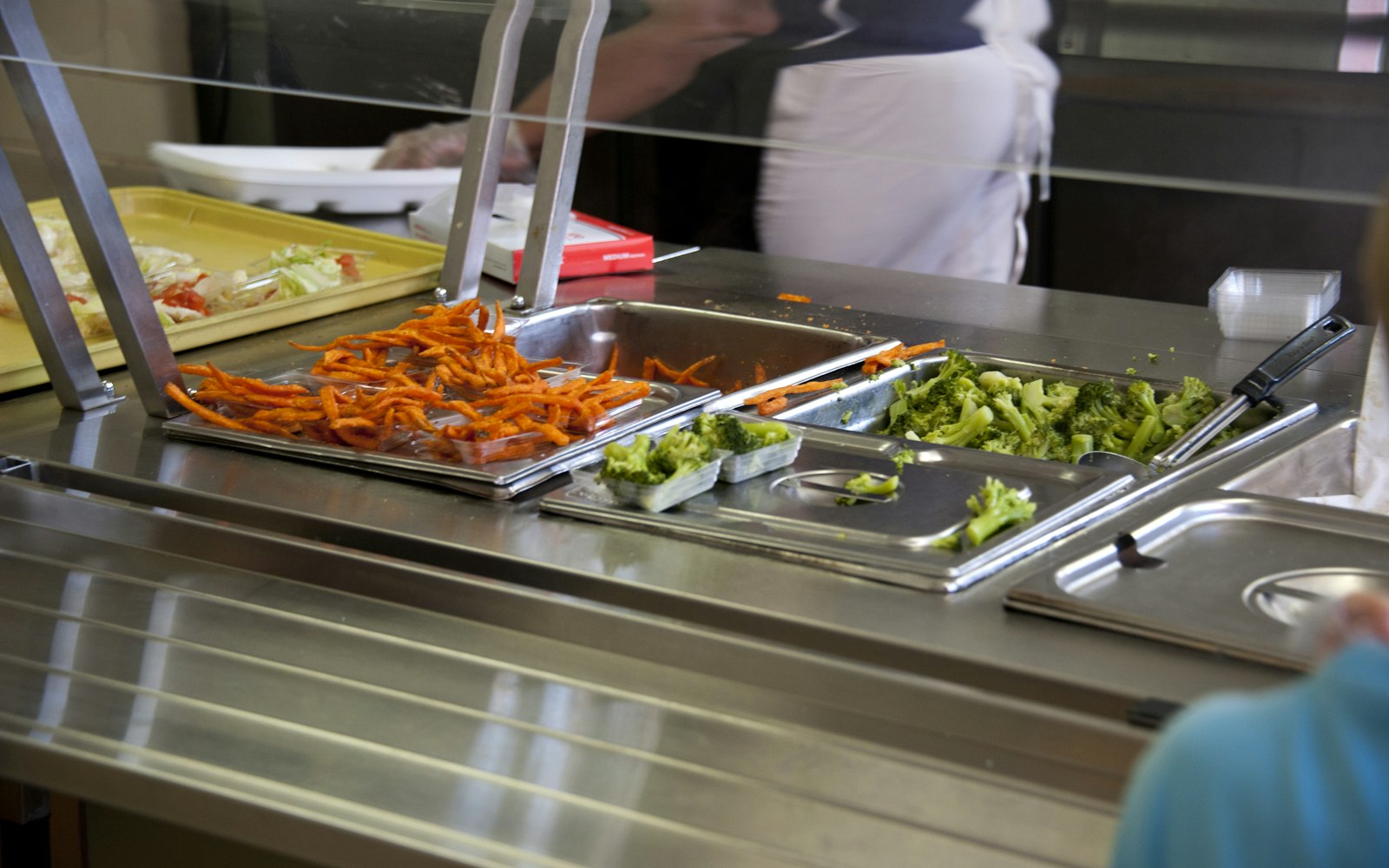 Línea de autoservicio de un comedor colectivo con bandejas de comida
